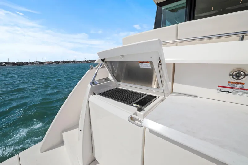 Slide: The Image of 2023 Tiara Yachts C49 Coupe outdoor grill on deck with ocean view. - 17