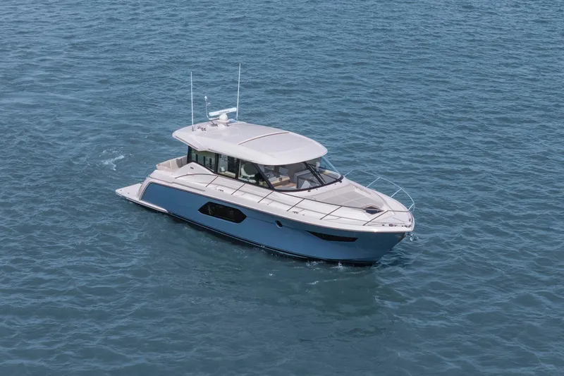 Slide: The Image of 2023 Tiara Yachts C49 Coupe cruising on open water. - 3