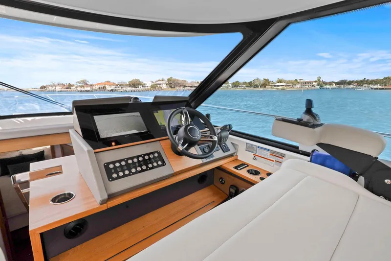 Slide: The Image of 2023 Tiara Yachts C49 Coupe helm with modern controls and scenic water view. - 31