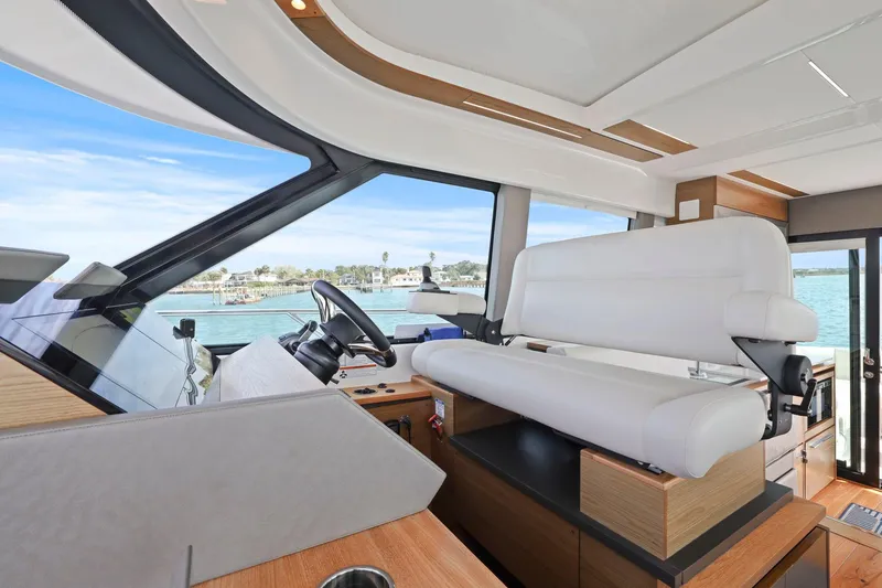 Slide: The Image of 2023 Tiara Yachts C49 Coupe interior with modern helm and panoramic windows. - 34