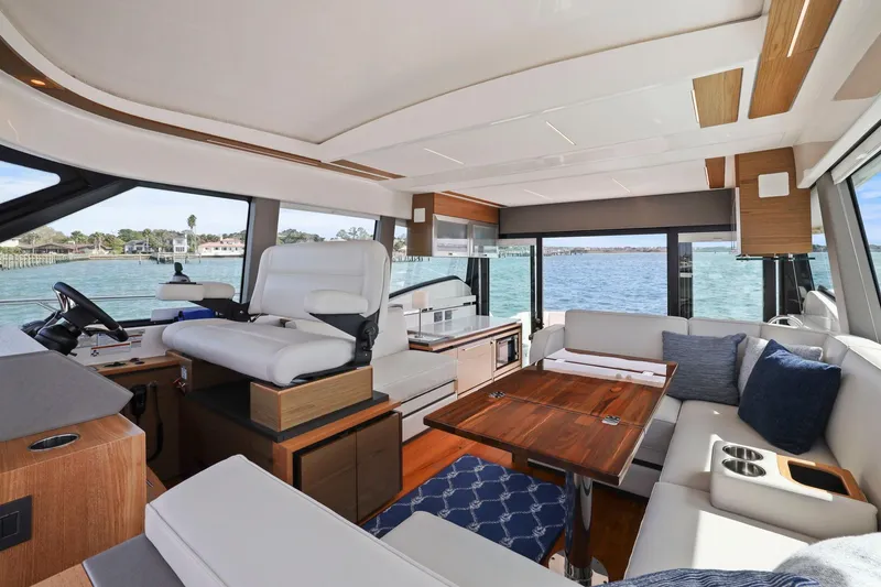 Slide: The Image of Luxurious interior of 2023 Tiara Yachts C49 Coupe with elegant seating and scenic water view. - 35