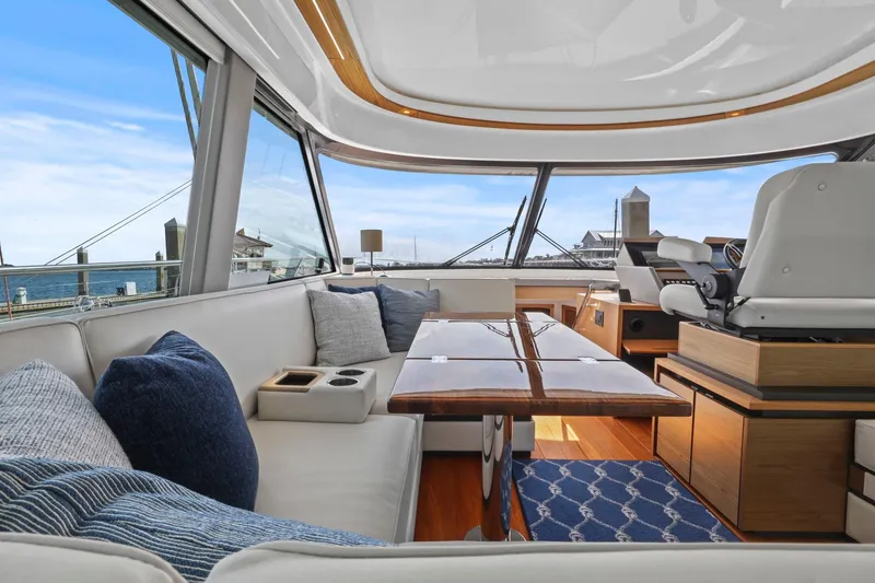 Slide: The Image of Luxurious interior of 2023 Tiara Yachts C49 Coupe with elegant seating and panoramic views. - 38