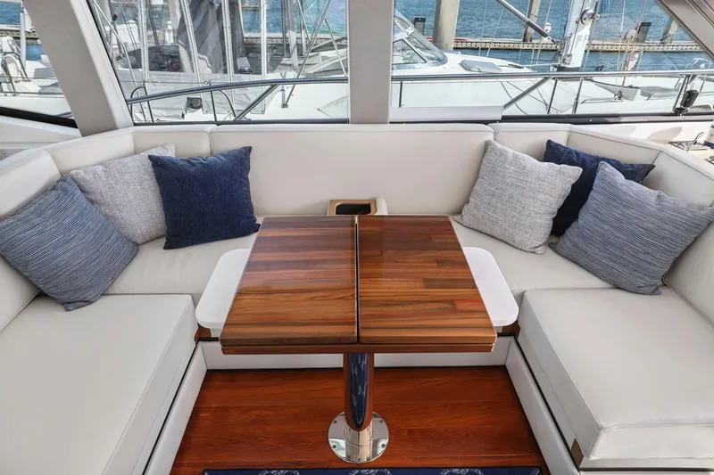 Slide: The Image of Luxurious seating area on 2023 Tiara Yachts C49 Coupe with elegant cushions and wooden table. - 39