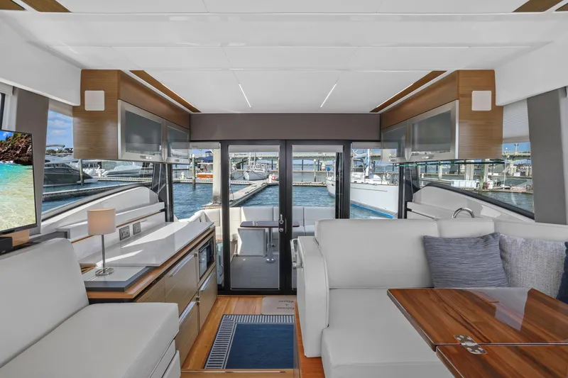 Slide: The Image of Luxurious interior of 2023 Tiara Yachts C49 Coupe with modern furnishings and marina view. - 41
