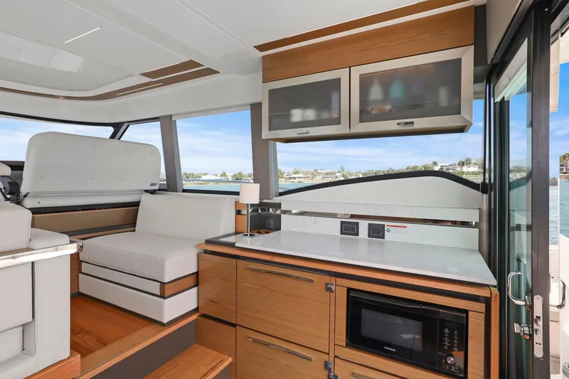 Slide: The Image of Luxurious interior of 2023 Tiara Yachts C49 Coupe with modern kitchen and seating area. - 42
