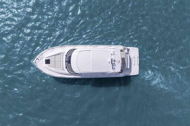 Slide: The Image of Aerial view of 2023 Tiara Yachts C49 Coupe on blue ocean water. - 5