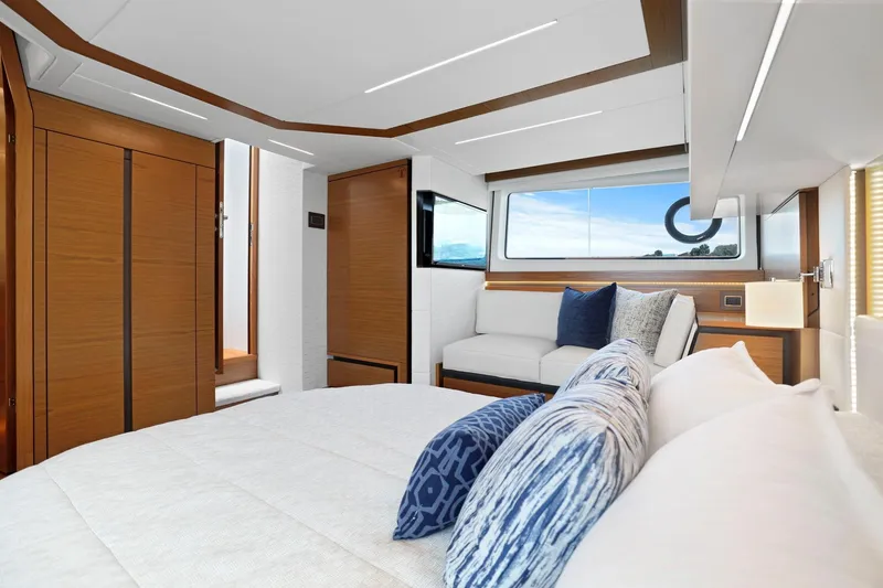 Slide: The Image of Luxurious interior of 2023 Tiara Yachts C49 Coupe with elegant wood finishes and plush seating. - 56