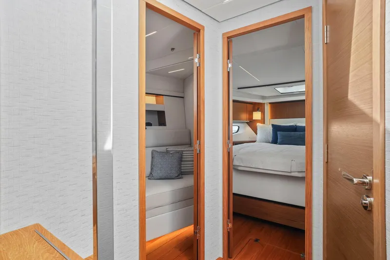 Slide: The Image of 2023 Tiara Yachts C49 Coupe interior with modern bedroom and seating area. - 62