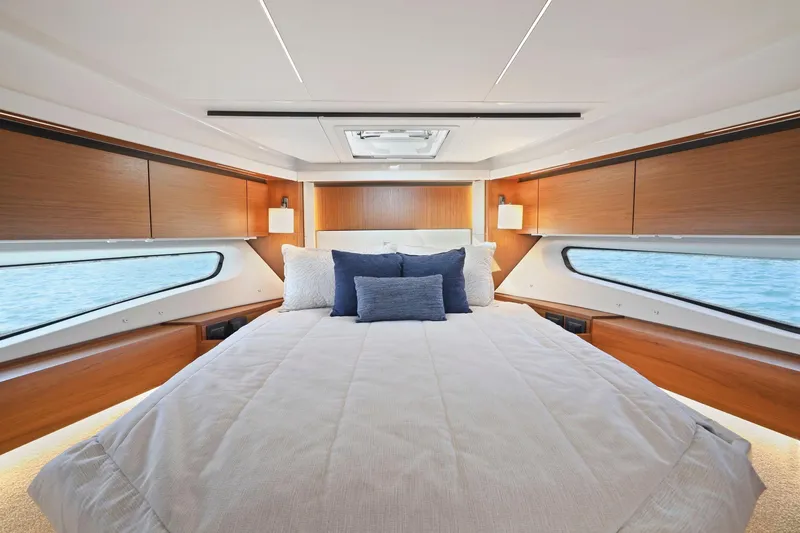 Slide: The Image of Luxurious bedroom interior of 2023 Tiara Yachts C49 Coupe with elegant wood finishes. - 63