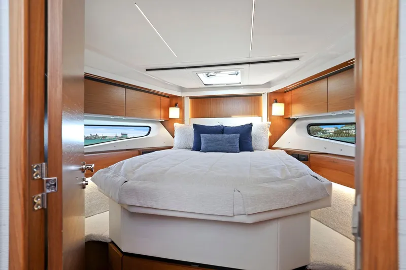 Slide: The Image of Luxurious bedroom interior of 2023 Tiara Yachts C49 Coupe with elegant wood finishes. - 64