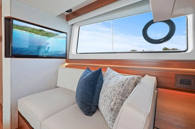 Slide: The Image of Luxurious interior of 2023 Tiara Yachts C49 Coupe with plush seating and scenic window view. - 66