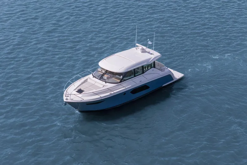 Slide: The Image of 2023 Tiara Yachts C49 Coupe cruising on open water, showcasing sleek design and luxury. - 7