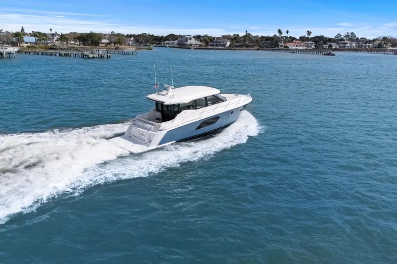 Slide: The Image of 2023 Tiara Yachts C49 Coupe cruising on open water. - 80