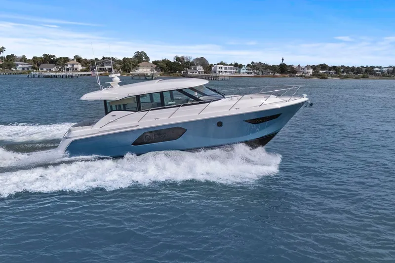 Slide: The Image of 2023 Tiara Yachts C49 Coupe cruising on open water, showcasing sleek design and performance. - 81