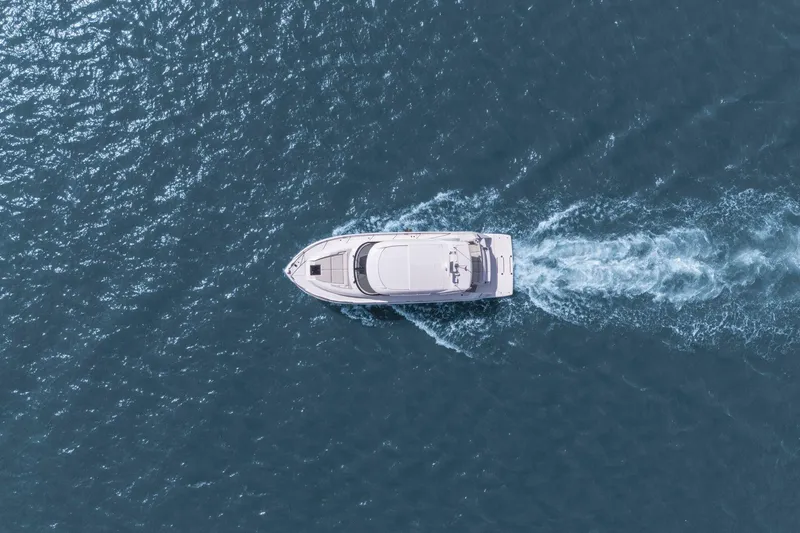 Slide: The Image of Aerial view of 2023 Tiara Yachts C49 Coupe cruising on open water. - 82