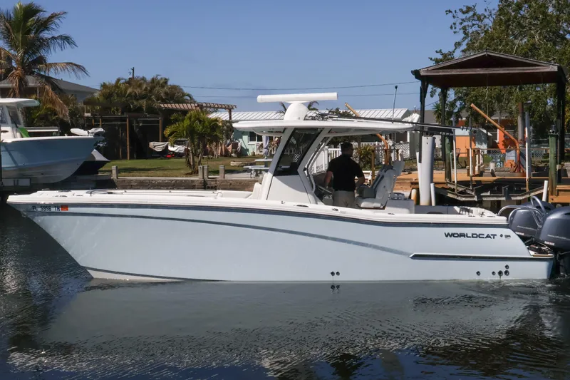 Slide: The Image of 2022 World Cat 280 CC-X boat docked in a sunny marina setting. - 1