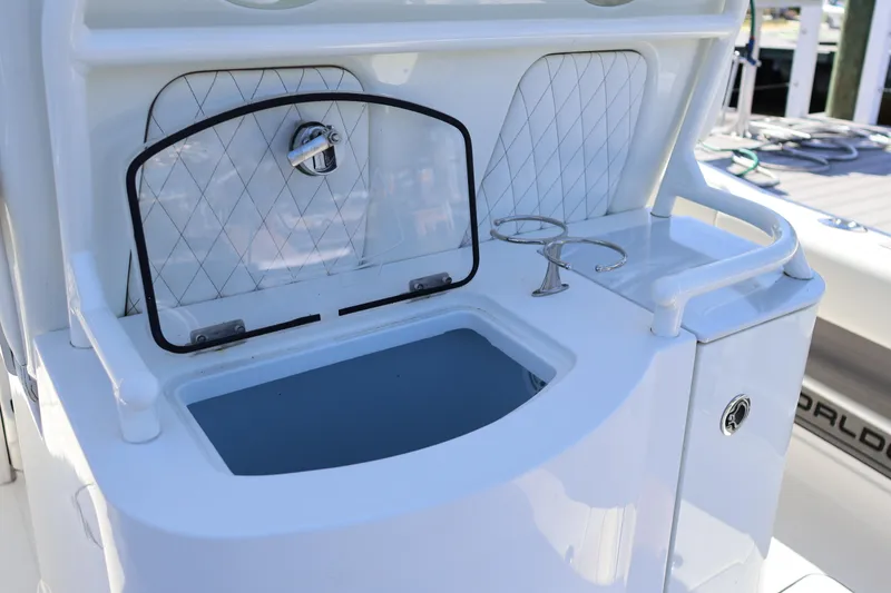 Slide: The Image of 2022 World Cat 280 CC-X boat with open storage compartment and cup holders. - 18