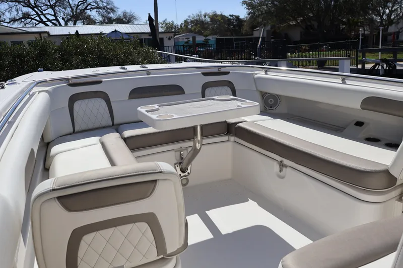 Slide: The Image of 2022 World Cat 280 CC-X boat interior with cushioned seating and table. - 35