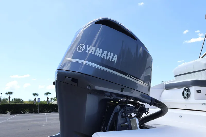 Slide: The Image of 2019 Regal 29 OBX with Yamaha four-stroke outboard motor in a parking lot. - 10