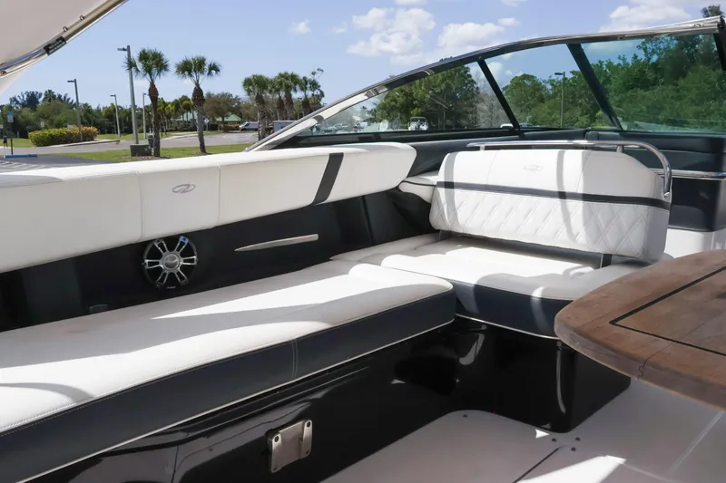 Slide: The Image of Luxurious interior of 2019 Regal 29 OBX boat with white seating and wooden table. - 21