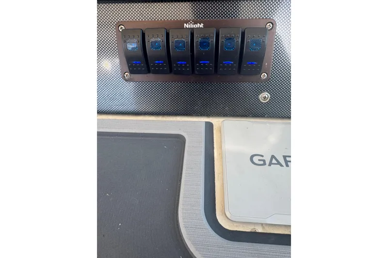 Slide: The Image of Control panel with switches on a 1984 Topaz 37 boat dashboard. - 11