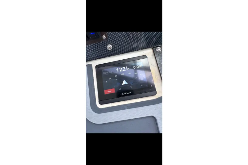 Slide: The Image of Garmin navigation display on 1984 Topaz 37 boat dashboard, showing heading and speed. - 4