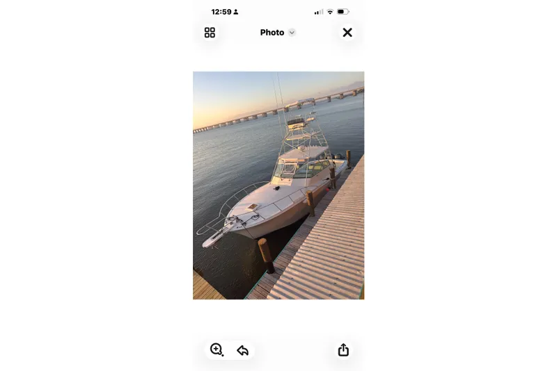 Slide: The Image of 1984 Topaz 37 boat docked at sunset with bridge in background. - 5