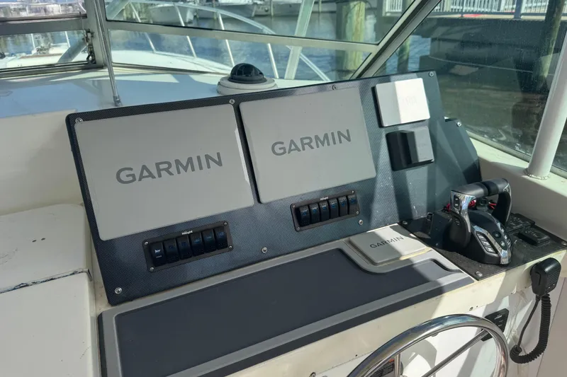Slide: The Image of Control panel of a 1984 Topaz 37 boat featuring Garmin navigation equipment. - 6