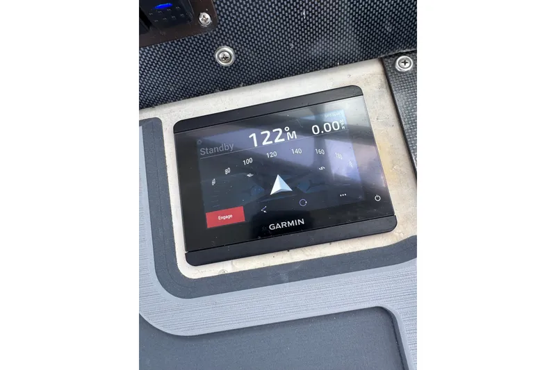 Slide: The Image of Garmin navigation display on 1984 Topaz 37 boat dashboard, showing compass and standby mode. - 7