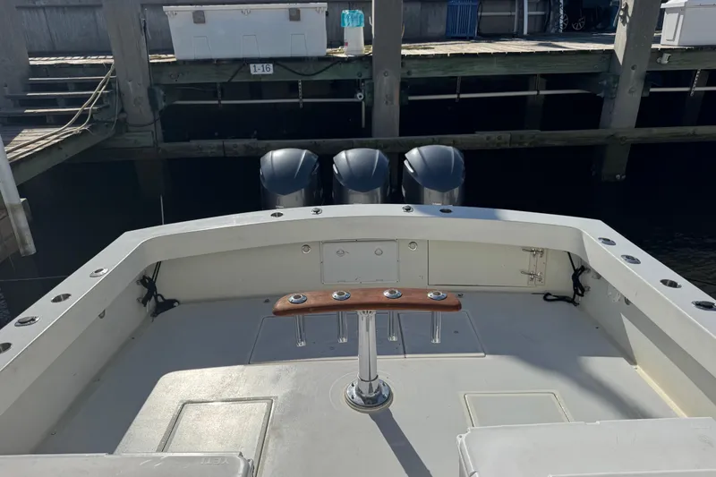 Slide: The Image of 1984 Topaz 37 boat with triple outboard motors docked at a marina. - 9