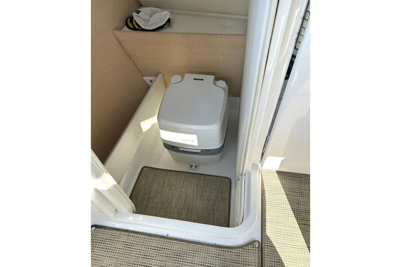 Slide: The Image of Portable toilet in 2017 Cobalt R5 boat cabin, featuring compact design and beige interior. - 11