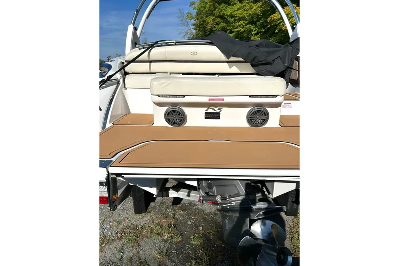 Slide: The Image of 2017 Cobalt R5 boat rear view with seating and speakers, parked outdoors. - 4