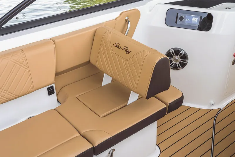 Slide: The Image of The image shows the luxurious interior of a Sea Ray SDX 230 boat with beige upholstery. - 13