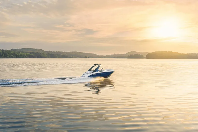 Slide: The Image of A Sea Ray SDX 230 boat glides across a calm lake at sunset. - 14