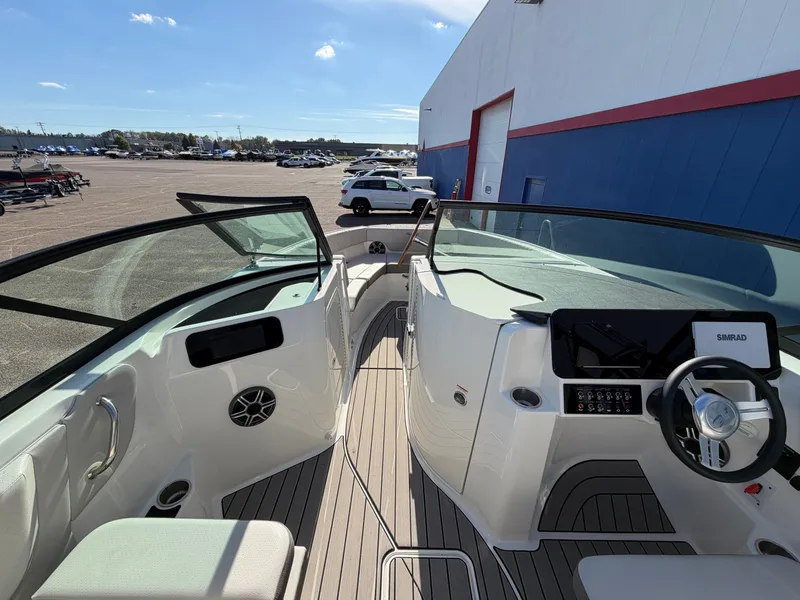 Slide: The Image of The image shows the cockpit of a 2026 Sea Ray SDX 230 boat with modern instruments. - 22