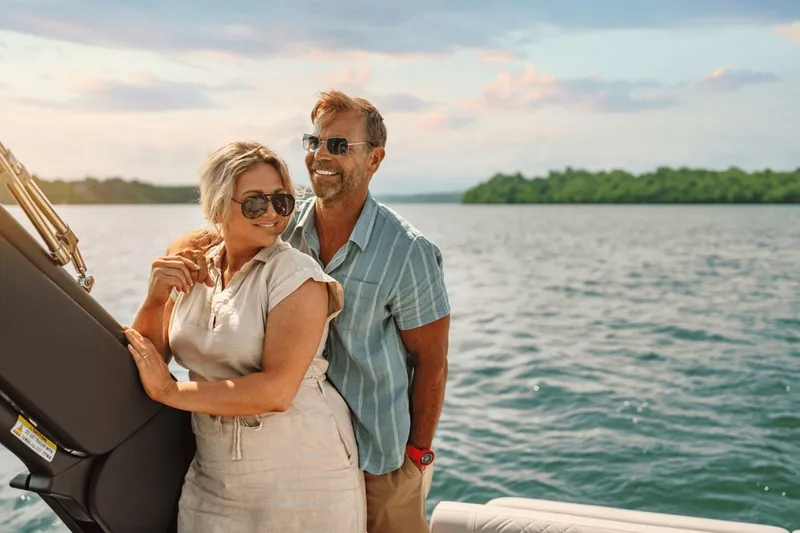 Slide: The Image of A couple enjoys a boat ride on a lake under sunny skies. - 26