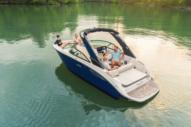Slide: The Image of 2026 Sea Ray SDX 230 on calm water with four people on board. - 8