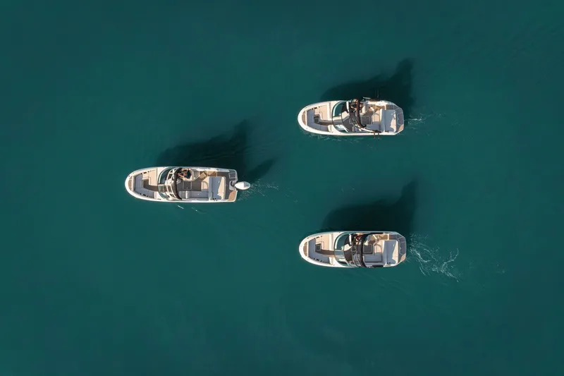 Slide: The Image of Three boats cruise on calm water, with a clear view of their decks and passengers. - 29