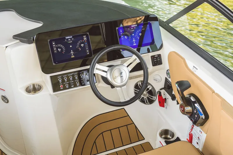 Slide: The Image of The 2026 Sea Ray SDX 230 cockpit features a modern dashboard with two display screens. - 2