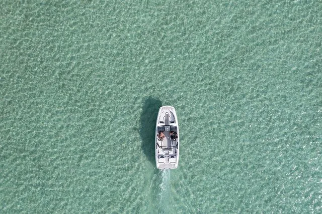 Slide: The Image of Scarab Jet Boats 235 SE 2027 on clear water from above. - 30