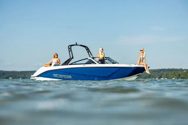 Slide: The Image of Scarab Jet Boats 235 SE 2027 on water with three people. - 31