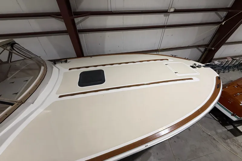 Slide: The Image of 1979 Magnum 38 Sport boat deck in a warehouse, showcasing sleek design and wood accents. - 13
