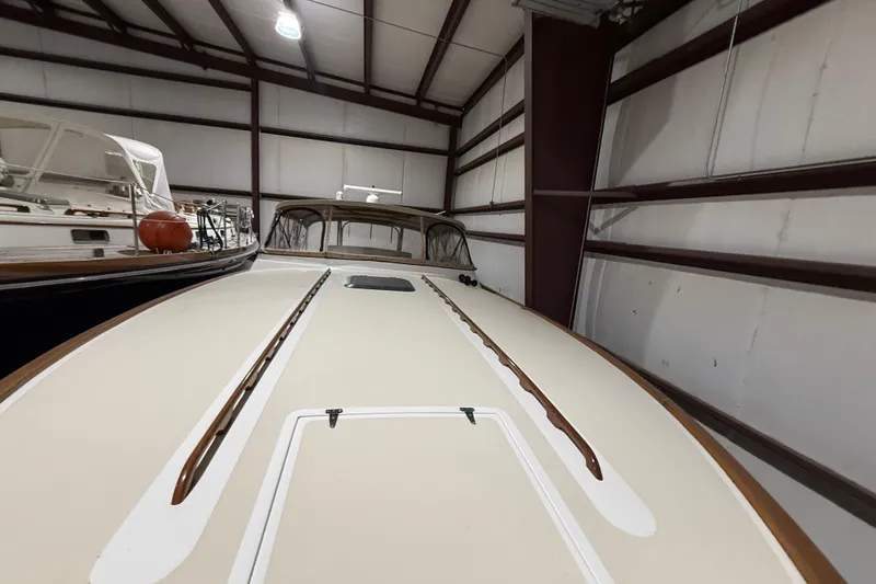 Slide: The Image of 1979 Magnum 38 Sport boat in storage, showcasing sleek deck design. - 14