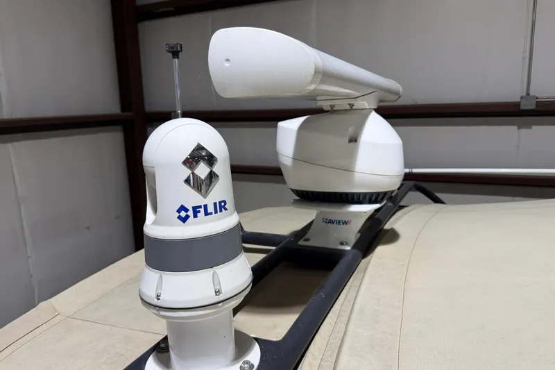 Slide: The Image of FLIR and Seaview equipment on 1979 Magnum 38 Sport boat, mounted on beige surface. - 16