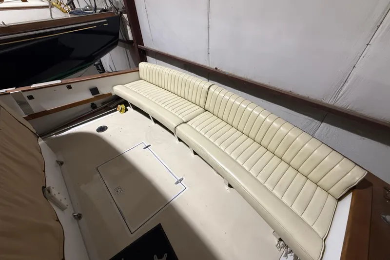 Slide: The Image of 1979 Magnum 38 Sport boat interior with cream leather seating in a storage facility. - 17