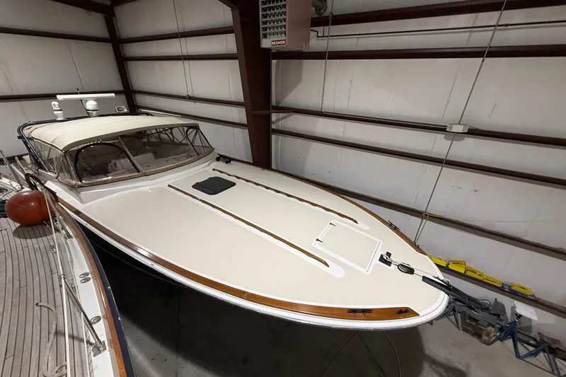 Slide: The Image of 1979 Magnum 38 Sport boat in storage, showcasing sleek design and classic features. - 4