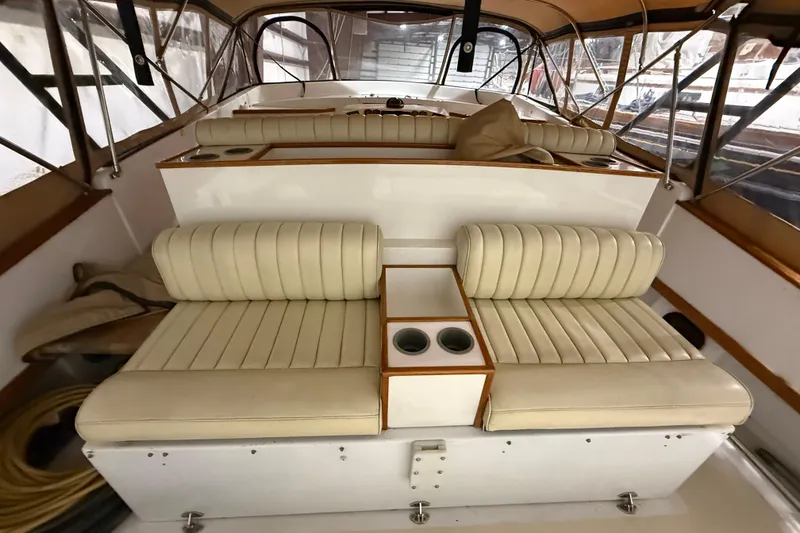 Slide: The Image of 1979 Magnum 38 Sport boat interior with beige leather seating and cup holders. - 22