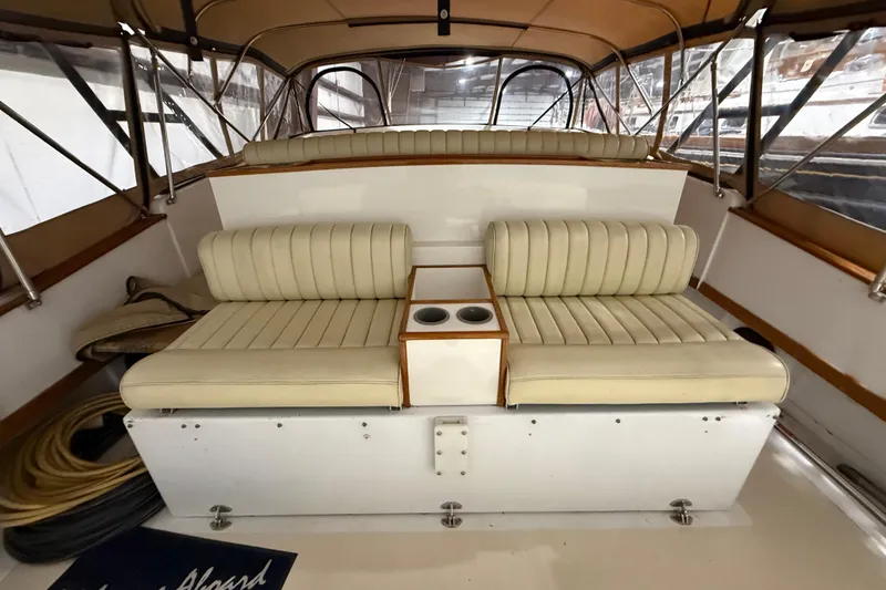 Slide: The Image of Interior of a 1979 Magnum 38 Sport boat with beige seating and cup holders. - 23