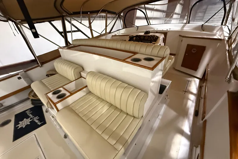 Slide: The Image of Interior of a 1979 Magnum 38 Sport boat with beige seating and wooden accents. - 24