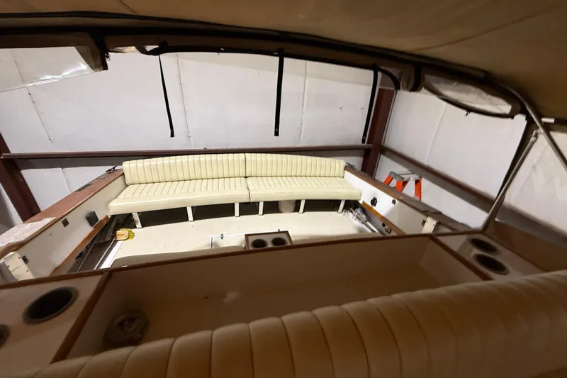 Slide: The Image of 1979 Magnum 38 Sport boat interior with beige seating and cup holders. - 25